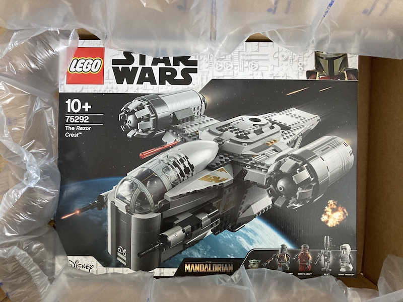 Boxed LEGO Razor Crest set in opened shipping box with padding